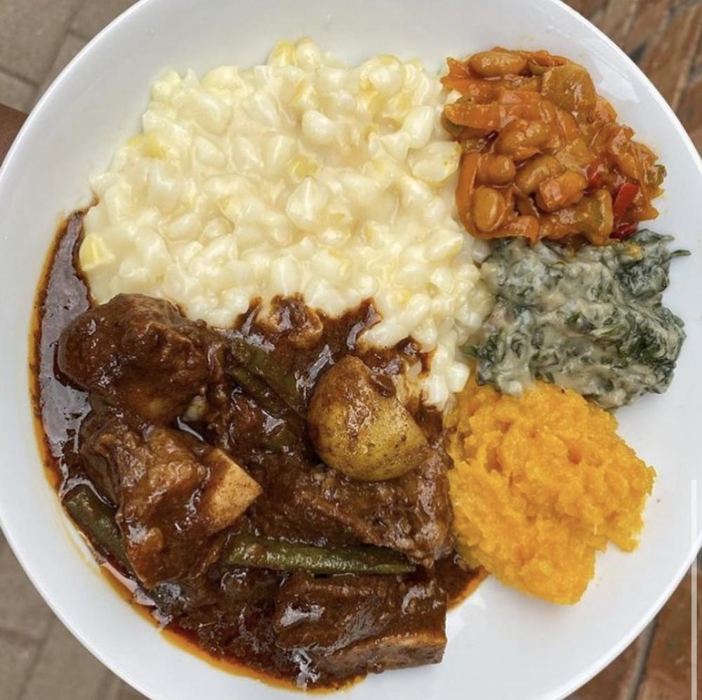 Traditional South African plate with beef stew and samp